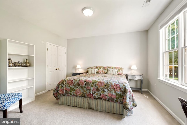 bedroom with carpet flooring, multiple windows, and baseboards