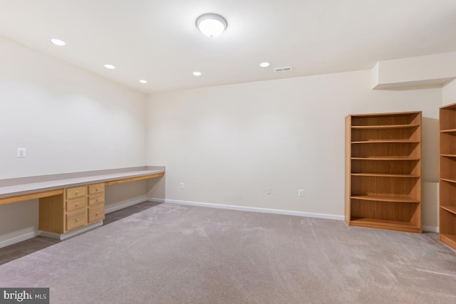 unfurnished office featuring built in study area, carpet, baseboards, and recessed lighting