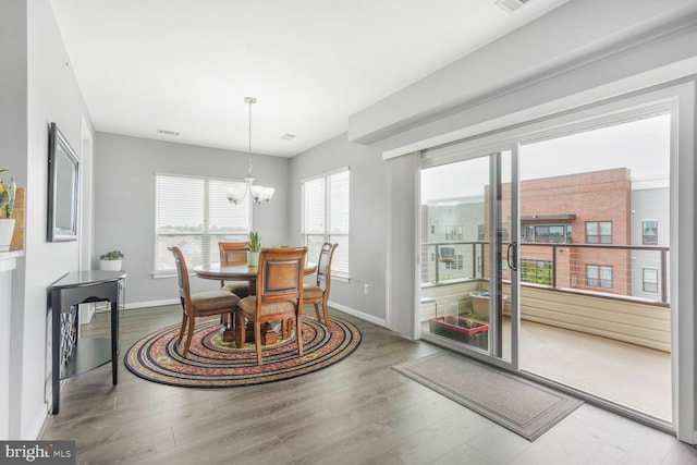 8960 Fascination Ct Unit 414, Lorton, VA 22079 - dining space with plenty of natural light, baseboards, a chandelier, and wood finished floors