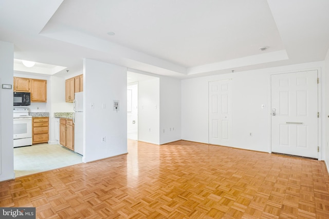 900 N Taylor St Unit 1105, Arlington, VA 22203 - unfurnished living room with a tray ceiling and baseboards