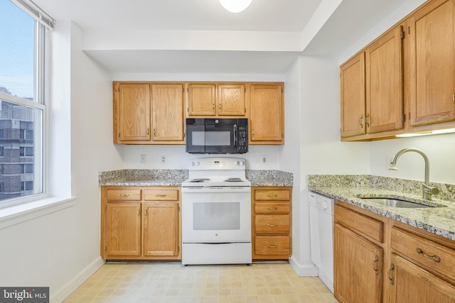 900 N Taylor St Unit 1105, Arlington, VA 22203 - kitchen featuring white appliances, a sink, light stone countertops, baseboards, and light floors