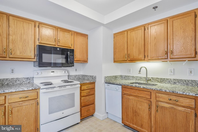 900 N Taylor St Unit 1105, Arlington, VA 22203 - kitchen with white appliances, a sink, light stone counters, and brown cabinetry