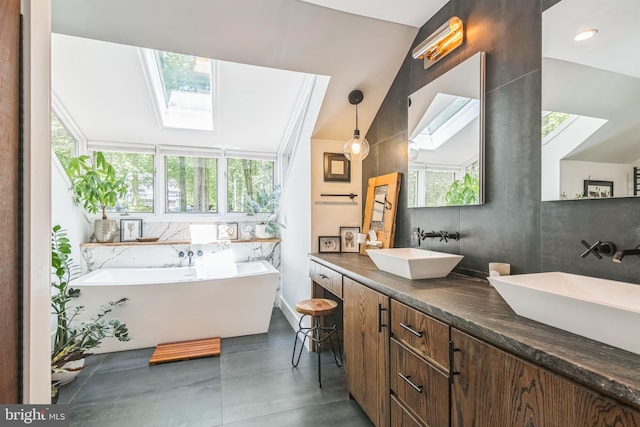 113 Sparrow Hawk Ln, Chadds Ford, PA 19317 - bathroom with a skylight, finished concrete floors, a soaking tub, and double vanity