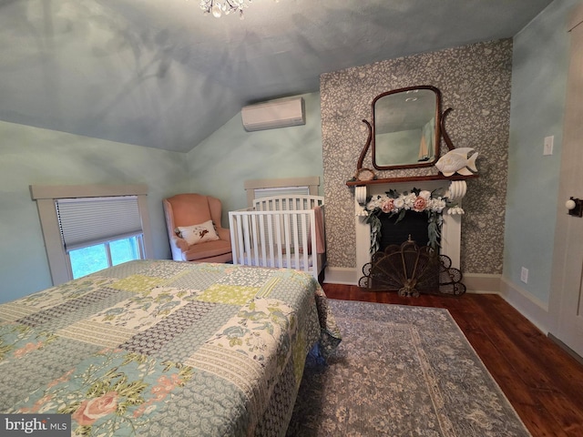 314 Bohemia Ave, Chesapeake City, MD 21915 - bedroom featuring a wall mounted AC, wood finished floors, vaulted ceiling, and baseboards