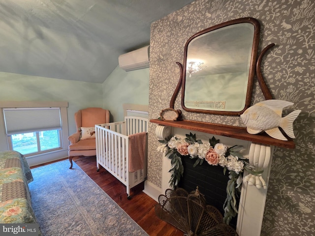 314 Bohemia Ave, Chesapeake City, MD 21915 - bedroom featuring a wall mounted AC, wood finished floors, lofted ceiling, wallpapered walls, and baseboards