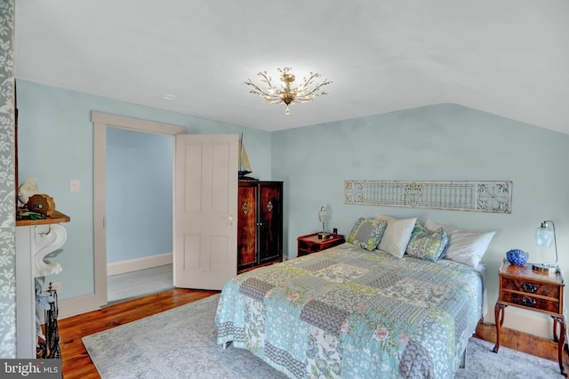 314 Bohemia Ave, Chesapeake City, MD 21915 - bedroom with wood finished floors, vaulted ceiling, and a chandelier