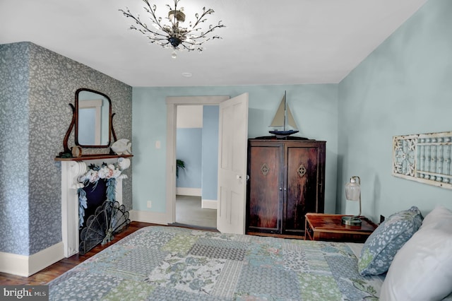 314 Bohemia Ave, Chesapeake City, MD 21915 - bedroom with a chandelier, wallpapered walls, and wood finished floors