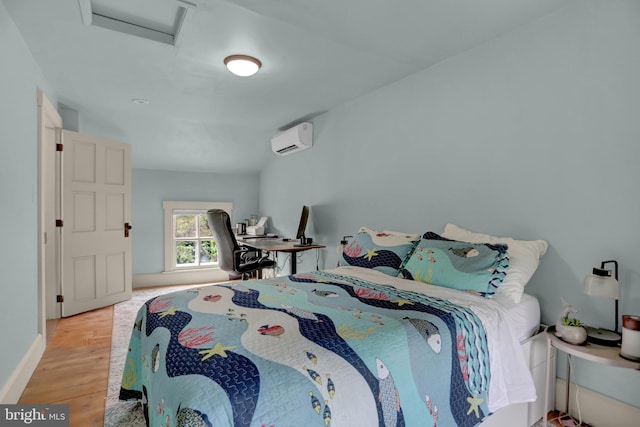 314 Bohemia Ave, Chesapeake City, MD 21915 - bedroom with a wall unit AC, attic access, and wood finished floors