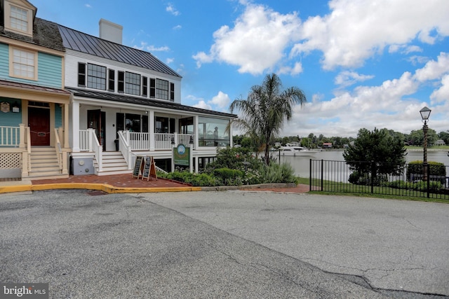314 Bohemia Ave, Chesapeake City, MD 21915 - view of front of property with a standing seam roof, a metal roof, a chimney, and covered porch