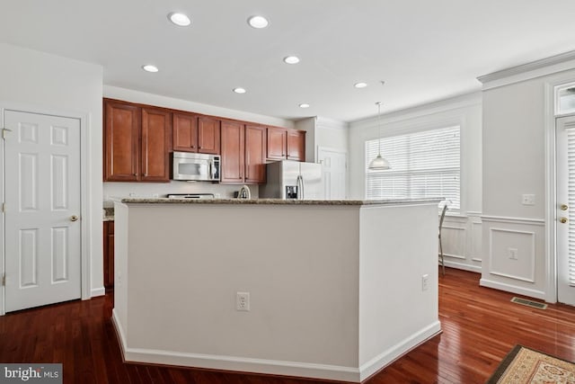 2529 Pascal Pl, Herndon, VA 20171 - kitchen with appliances with stainless steel finishes, hanging light fixtures, dark wood finished floors, recessed lighting, and light stone counters