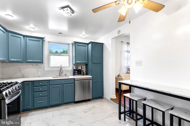 602 Lippincott Ave, Riverton, NJ 08077 - kitchen featuring stainless steel appliances, a sink, light marble finish flooring, and blue cabinetry