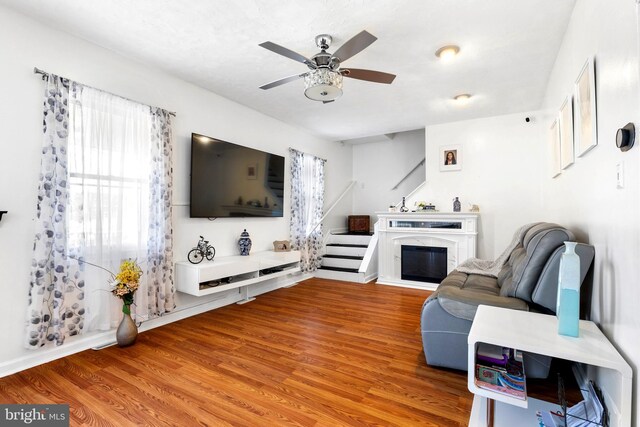 602 Lippincott Ave, Riverton, NJ 08077 - living area featuring wood finished floors, ceiling fan, stairway, and a high end fireplace