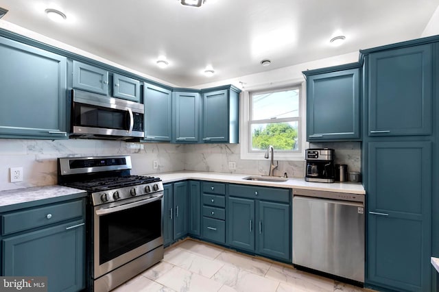 602 Lippincott Ave, Riverton, NJ 08077 - kitchen with appliances with stainless steel finishes, a sink, light marble finish flooring, light countertops, and blue cabinets