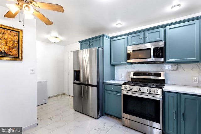 602 Lippincott Ave, Riverton, NJ 08077 - kitchen featuring stainless steel appliances, blue cabinets, light marble finish floors, and light countertops