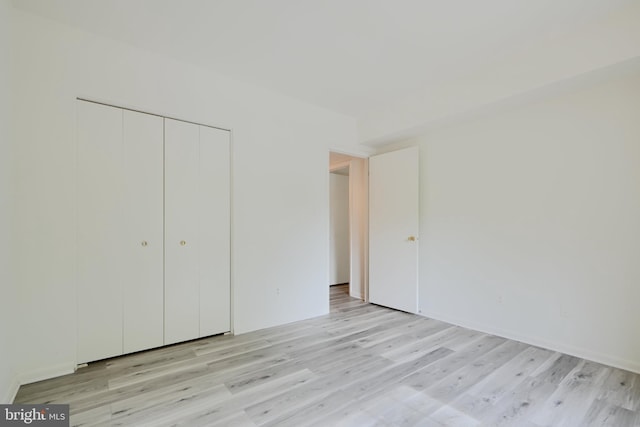 1 Brooking Ct Unit 202, Lutherville Timonium, MD 21093 - unfurnished bedroom with light wood-style floors and a closet