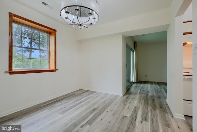 1 Brooking Ct Unit 202, Lutherville Timonium, MD 21093 - unfurnished dining area featuring light wood-style floors, a chandelier, and baseboards