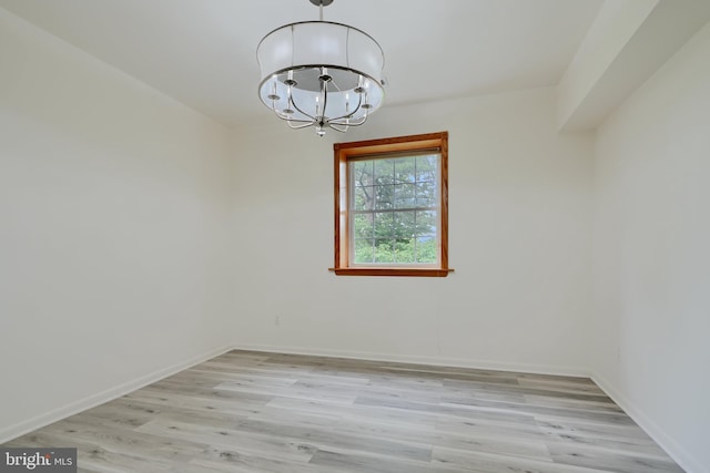 1 Brooking Ct Unit 202, Lutherville Timonium, MD 21093 - empty room with a chandelier, light wood-style flooring, and baseboards