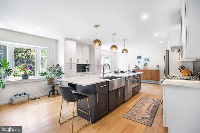 36 Gettysburg Ln, Newtown, PA 18940 - kitchen featuring a sink, stainless steel appliances, a kitchen island with sink, white cabinetry, and light countertops