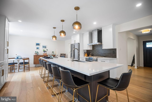 36 Gettysburg Ln, Newtown, PA 18940 - kitchen with wall chimney exhaust hood, stainless steel appliances, a sink, light wood-style floors, and recessed lighting