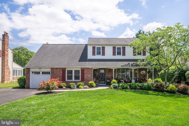 36 Gettysburg Ln, Newtown, PA 18940 - view of front facade with an attached garage, covered porch, brick siding, a front lawn, and driveway