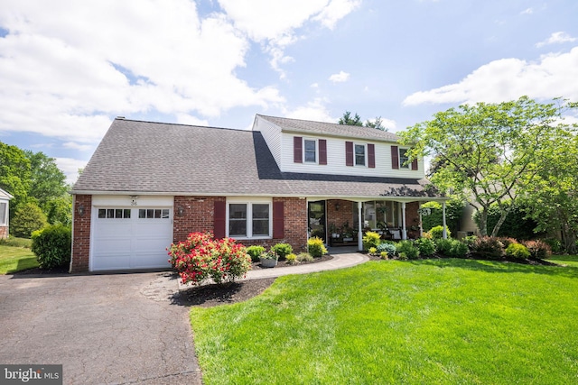 36 Gettysburg Ln, Newtown, PA 18940 - traditional home featuring an attached garage, brick siding, a front lawn, and a porch