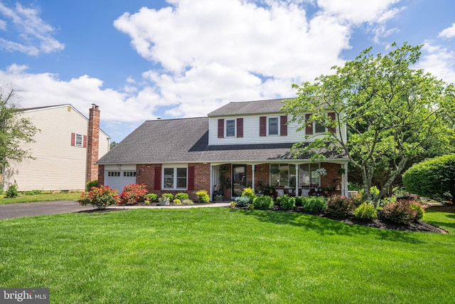 36 Gettysburg Ln, Newtown, PA 18940 - traditional-style house featuring brick siding, a garage, a front lawn, driveway, and a porch