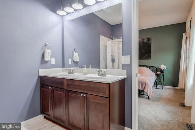 bathroom with baseboards, double vanity, and a shower with shower curtain