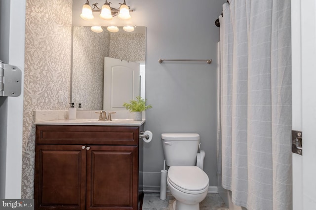 full bathroom featuring toilet, vanity, and curtained shower