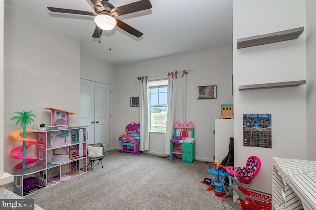 recreation room with ceiling fan, carpet floors, and baseboards
