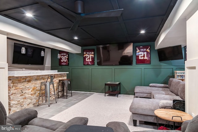 living area featuring a decorative wall, a dry bar, and recessed lighting
