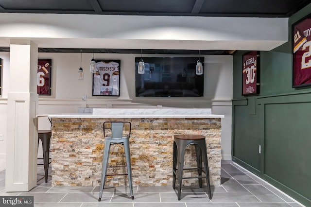 indoor bar featuring tile patterned floors