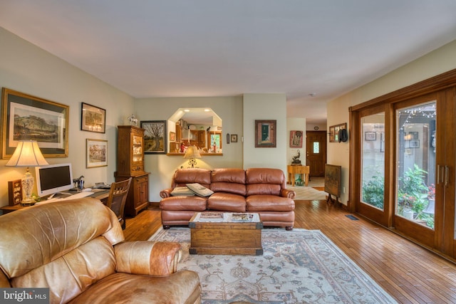 3012 Duncan Rd, White Hall, MD 21161 - living area featuring wood-type flooring, baseboards, and arched walkways