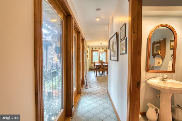 3012 Duncan Rd, White Hall, MD 21161 - corridor with light tile patterned floors, a chandelier, and baseboards