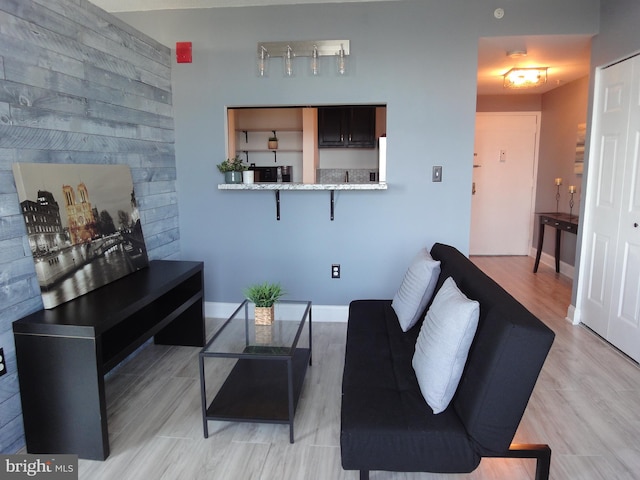 living room featuring baseboards and light wood-style floors