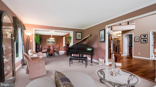 living area with crown molding, baseboards, and stairway