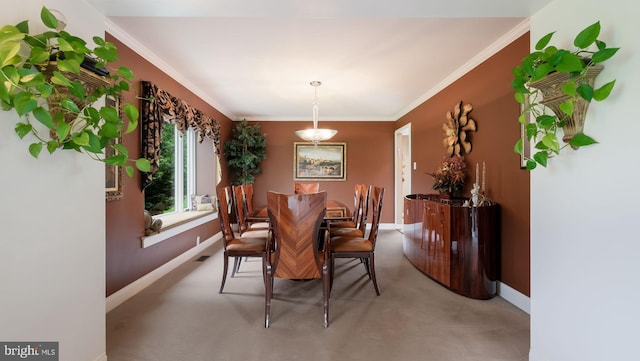 dining room with light colored carpet, baseboards, and ornamental molding