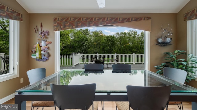 sunroom / solarium featuring vaulted ceiling and healthy amount of natural light