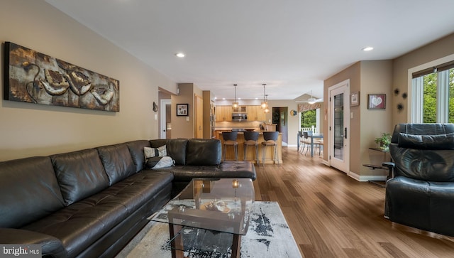 living area featuring dark wood-style floors, recessed lighting, and baseboards