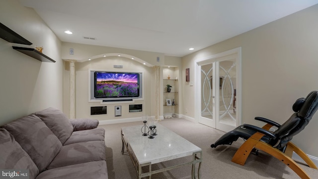 carpeted cinema featuring built in shelves, recessed lighting, and baseboards