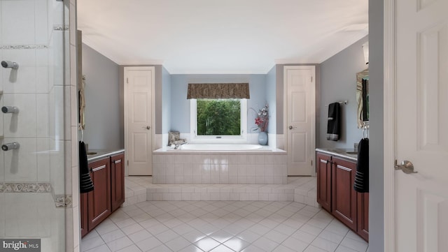 bathroom with tile patterned flooring, vanity, a garden tub, and a shower stall