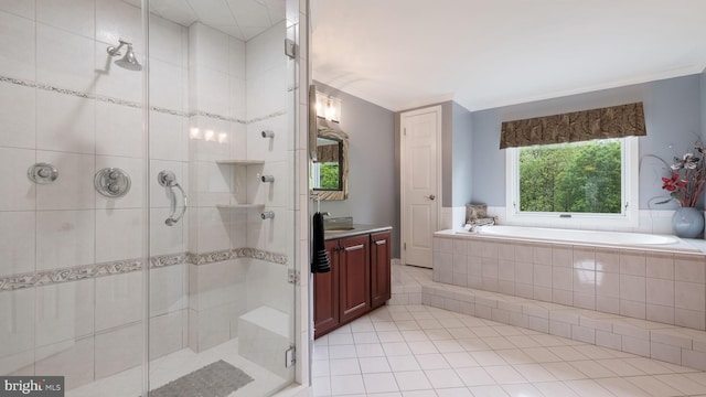 bathroom featuring a bath, vanity, a shower stall, tile patterned flooring, and ornamental molding