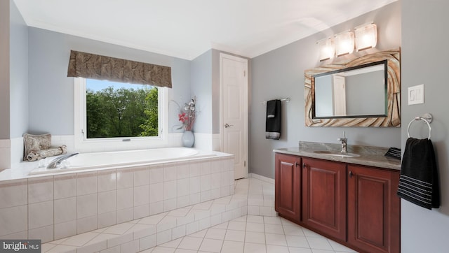 bathroom featuring a bath, tile patterned floors, and vanity
