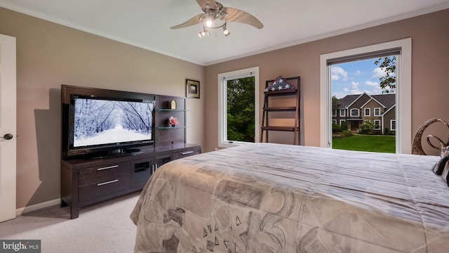 bedroom featuring access to outside, light colored carpet, ornamental molding, baseboards, and a ceiling fan
