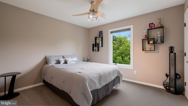 carpeted bedroom featuring baseboards and ceiling fan