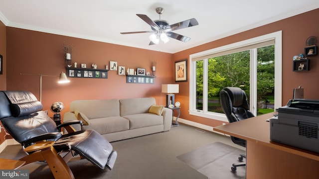 carpeted office with a ceiling fan, baseboards, and crown molding