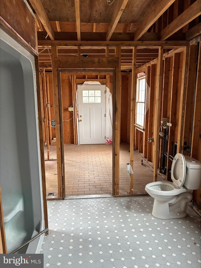 bathroom with toilet and tile patterned floors