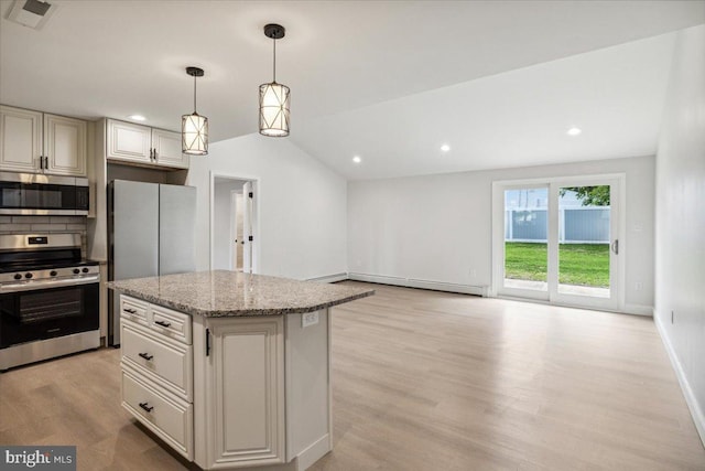 119 Oaktree Dr, Levittown, PA 19055 - kitchen with stainless steel appliances, light wood-style floors, light stone countertops, a baseboard radiator, and decorative light fixtures