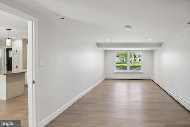 119 Oaktree Dr, Levittown, PA 19055 - spare room featuring a baseboard heating unit, a smoke detector, light wood finished floors, baseboards, and recessed lighting