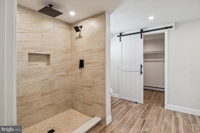 119 Oaktree Dr, Levittown, PA 19055 - bathroom with baseboard heating, wood finished floors, a tile shower, toilet, and baseboards