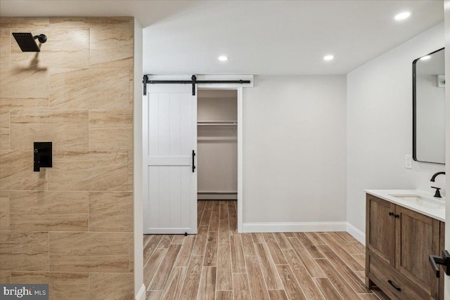 119 Oaktree Dr, Levittown, PA 19055 - full bathroom featuring a baseboard radiator, vanity, wood finished floors, tiled shower, and recessed lighting